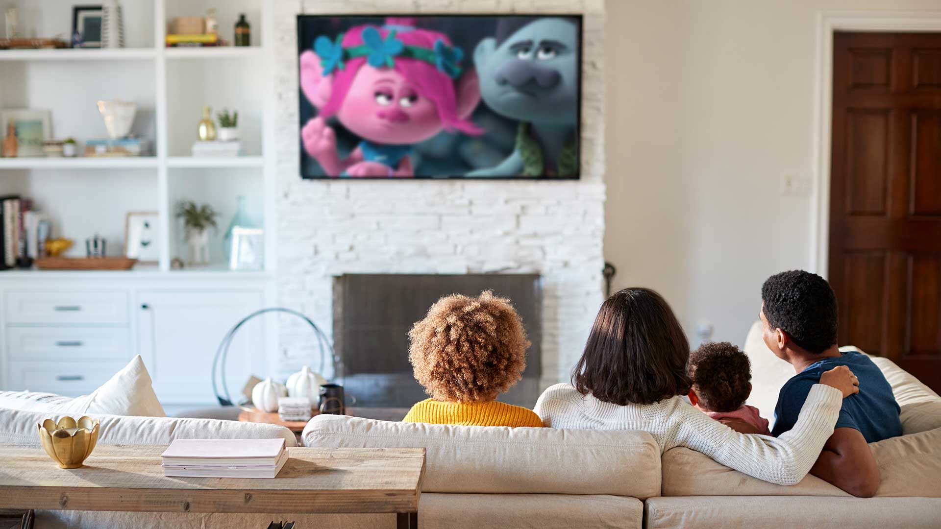 A family watches 'Trolls' on a TV