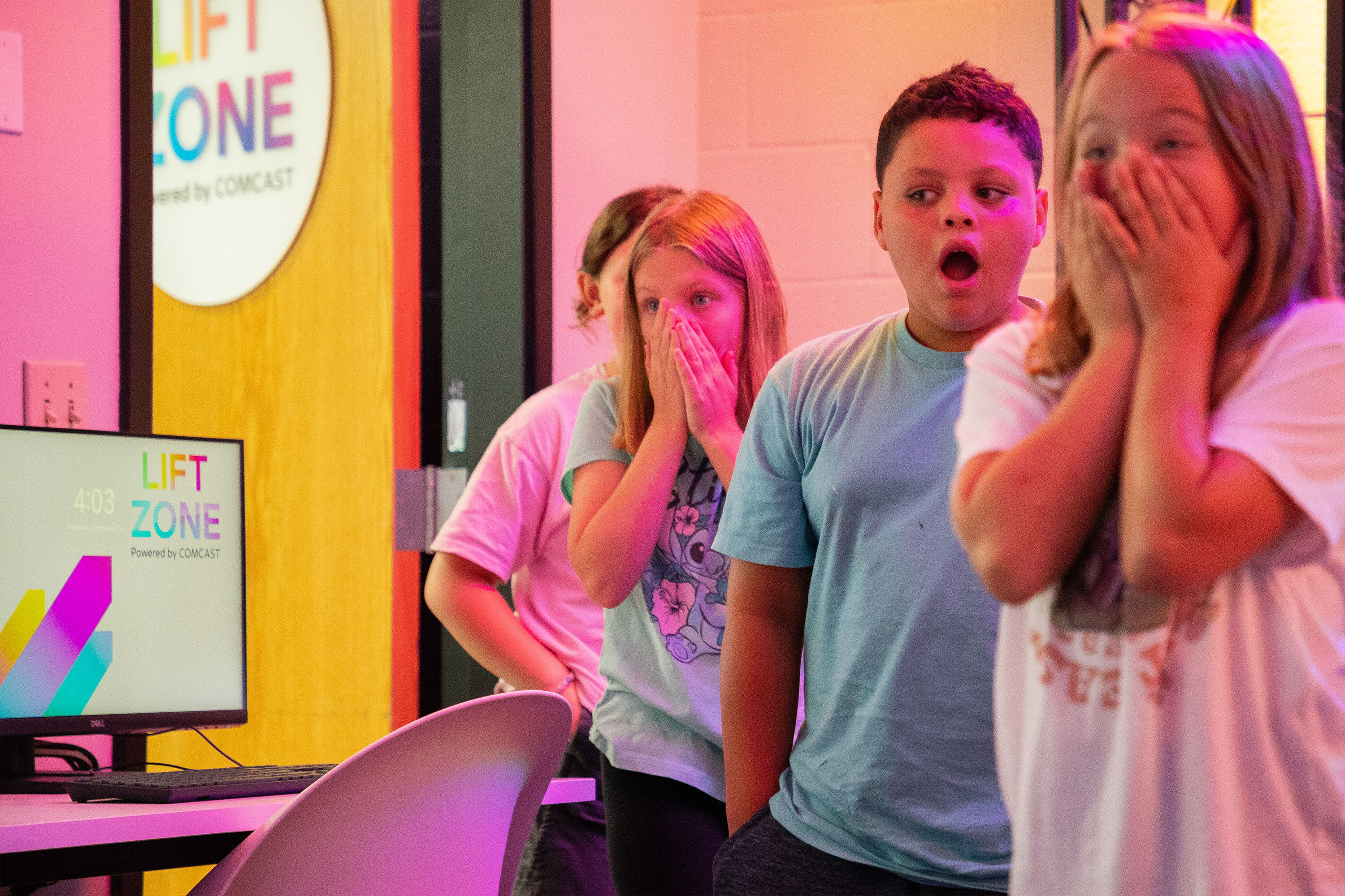 Three students celebrating during a Project UP event in a Lift Zone