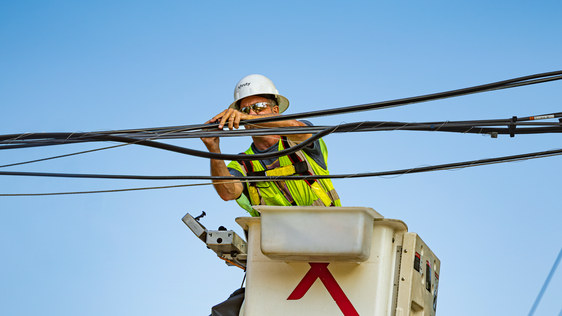 An Xfinity lineman working on a cable