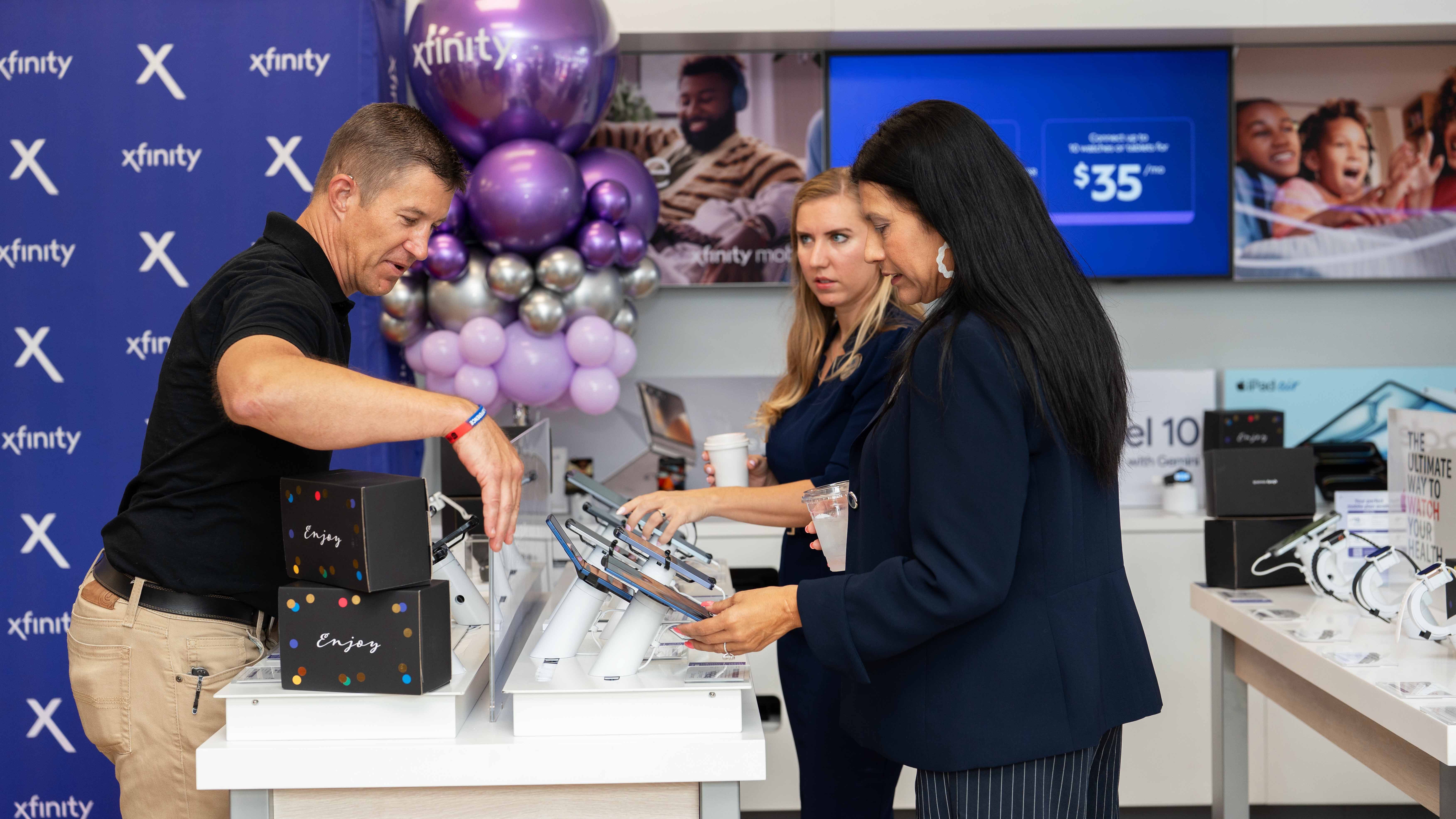 Guests explore Xfinity products and services inside the new Jacksonville store during the grand opening celebration.
