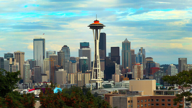 Wide shot of the Seattle skyline featuring the Space Needle against a clear blue sky