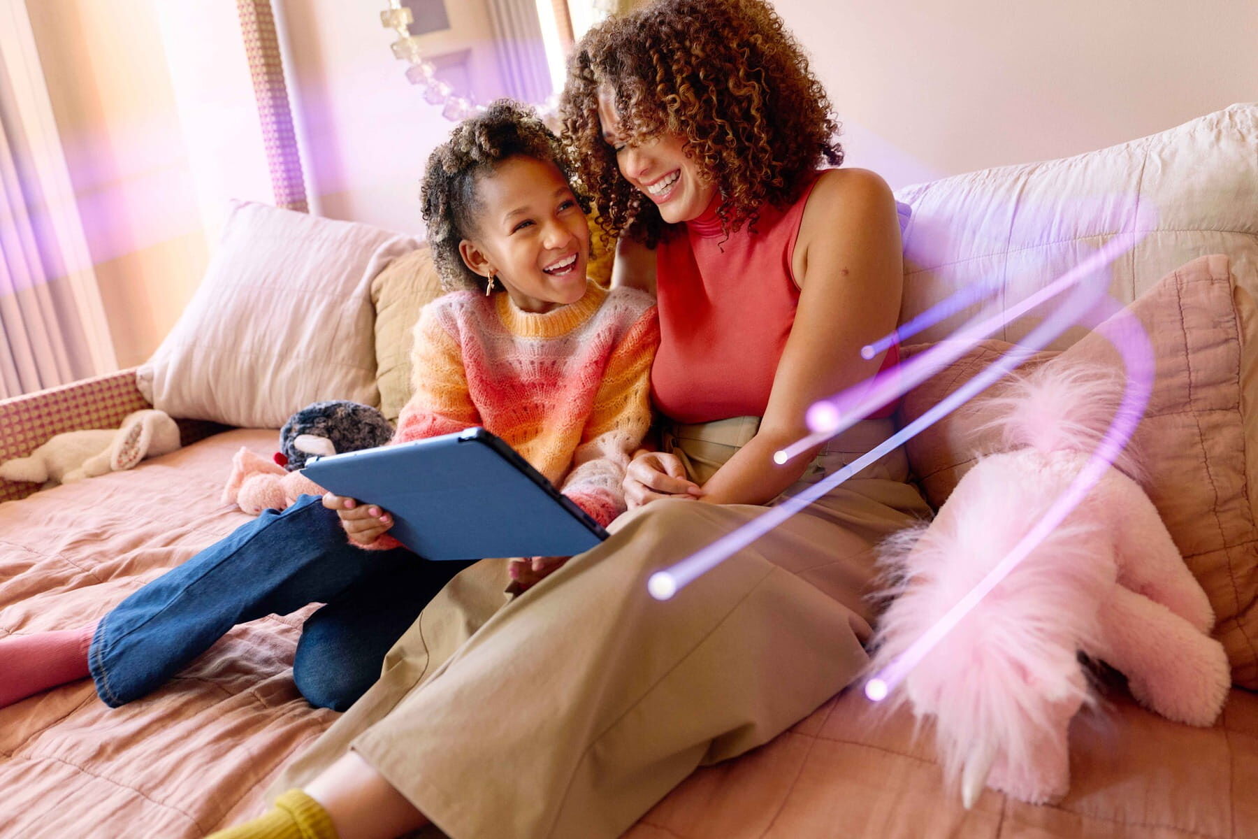 A child and a woman sitting on a bed, looking at a tablet together with soft purple light effects across the scene